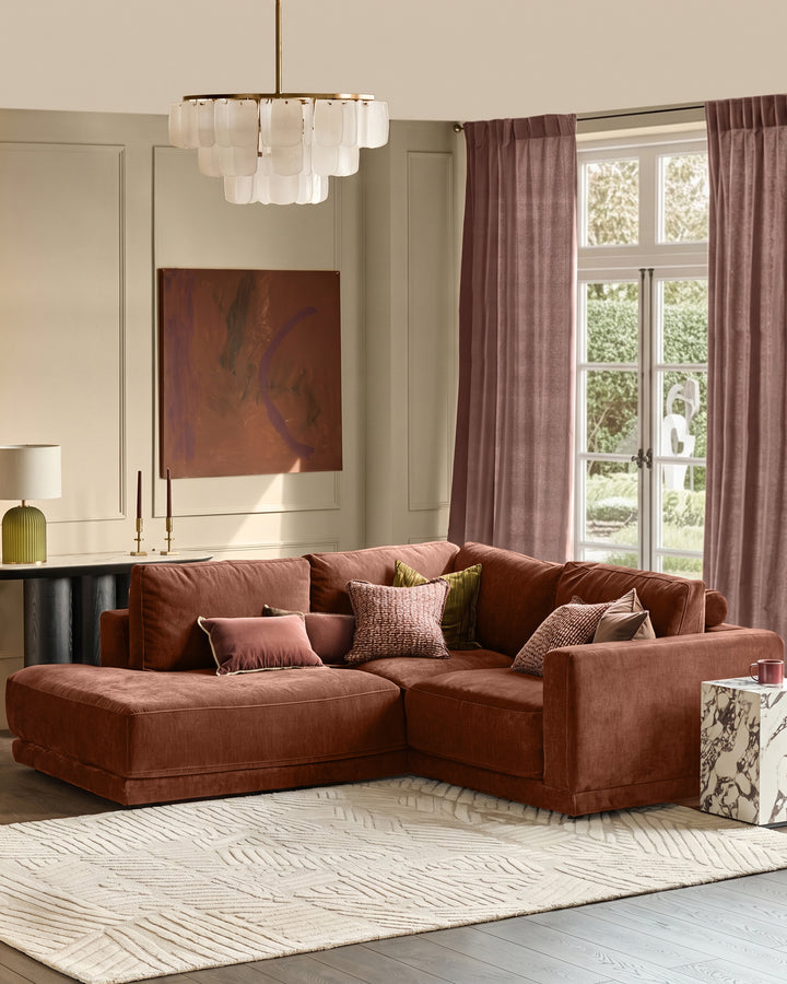 Eden left small chaise sofa in apricot fabric, styled in a modern living room with decorative pillows and neutral décor.
