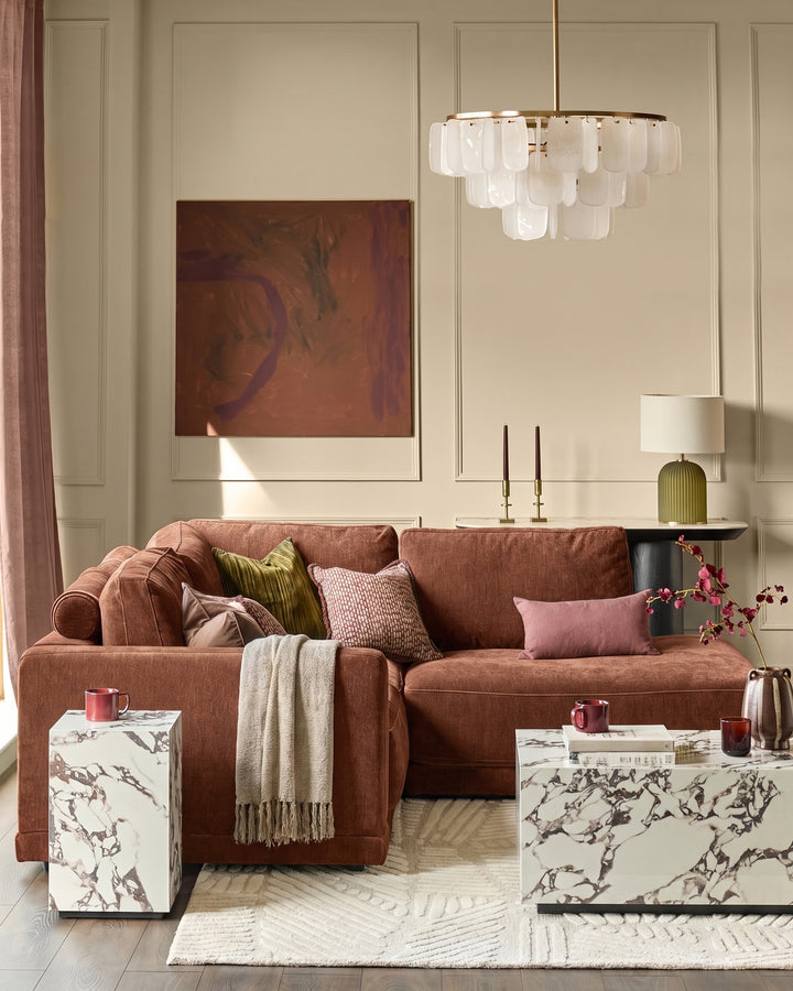 Eden right small chaise sofa in apricot fabric, displayed in a styled living room setting with coordinating pillows and throws.