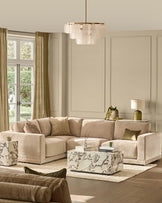 Eden small corner sofa in champagne fabric, styled in a bright living room with coordinating pillows and marble coffee table.