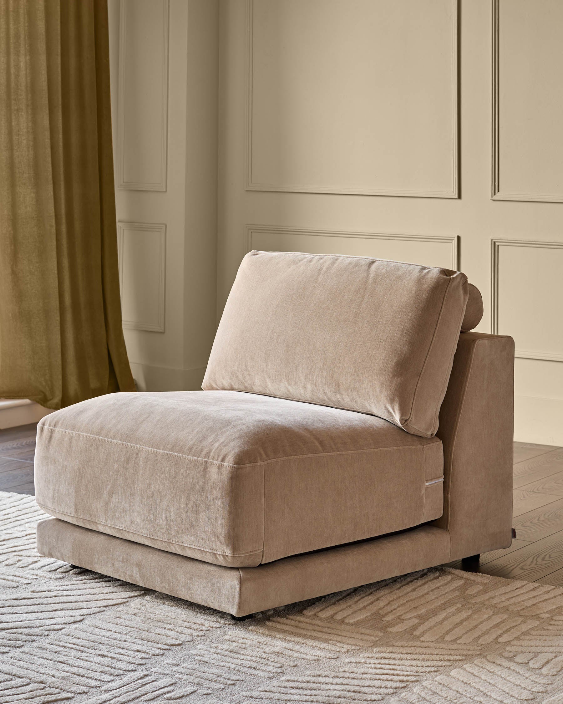 Champagne fabric single-module armchair with rolled arm and cushioned seat in modern living room setting.