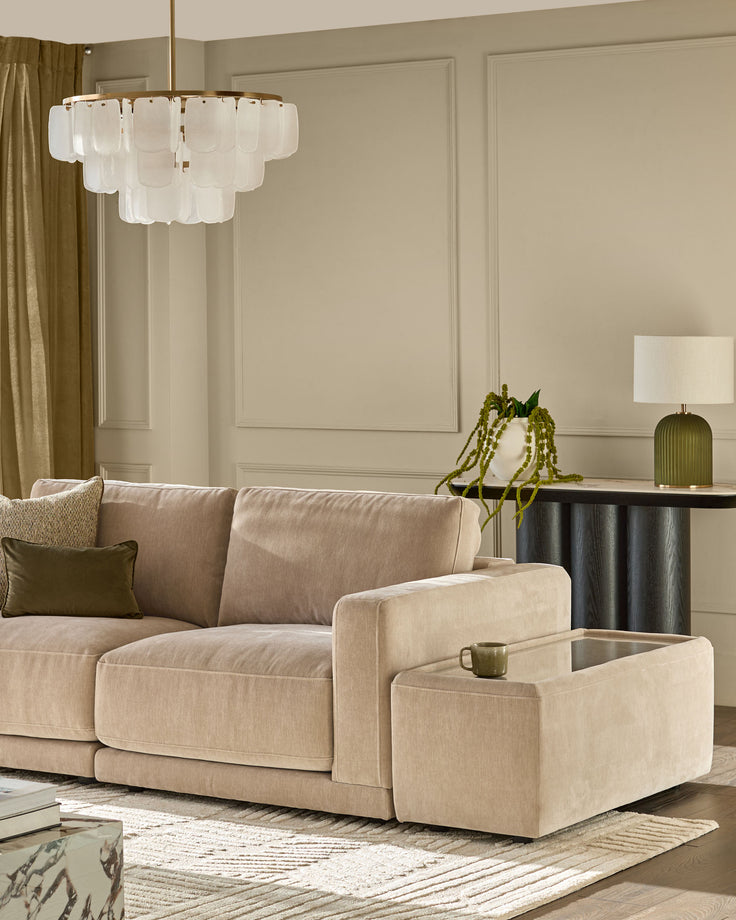 Eden side table module in champagne fabric with glass top, shown in modern living room setting.