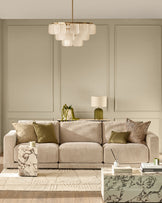 Eden 3-seater sofa in champagne fabric, displayed in a modern living room setting with coordinating pillows.
