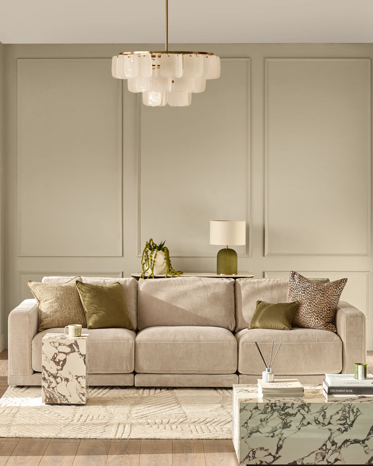 Eden 3-seater sofa in champagne fabric, displayed in a modern living room setting with coordinating pillows.