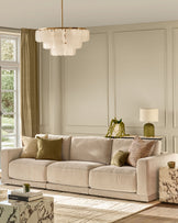 Eden 3-seater sofa in champagne fabric with plush cushions and track arms in a bright, neutral living room setting.