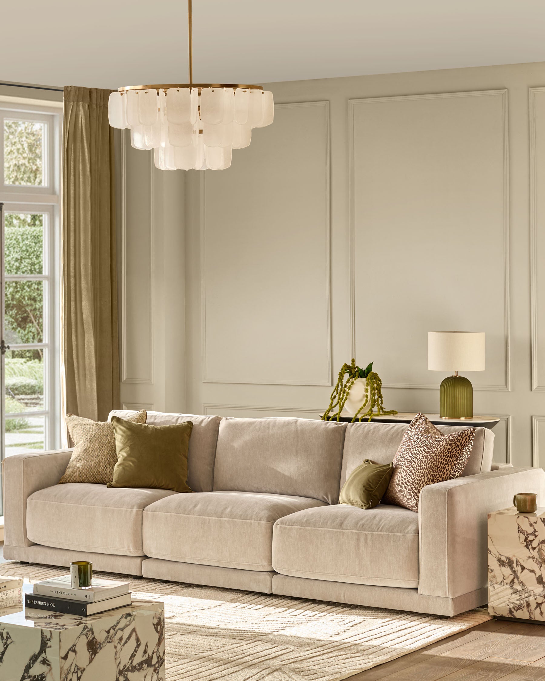 Eden 3-seater sofa in champagne fabric with plush cushions and track arms in a bright, neutral living room setting.
