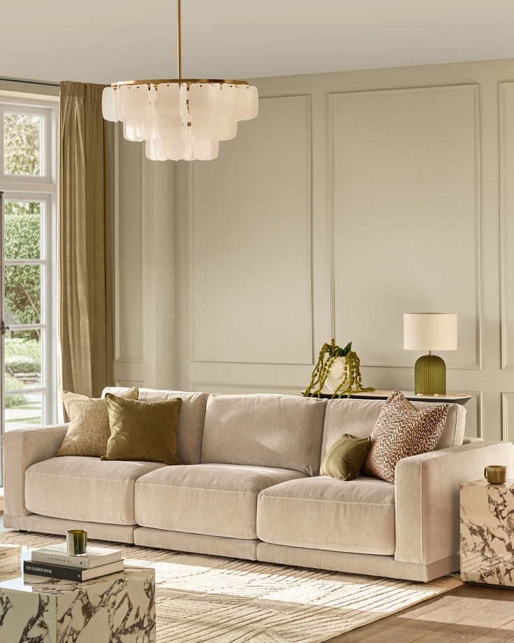 Eden 3-seater sofa in champagne fabric with plush cushions and track arms in a bright, neutral living room setting.