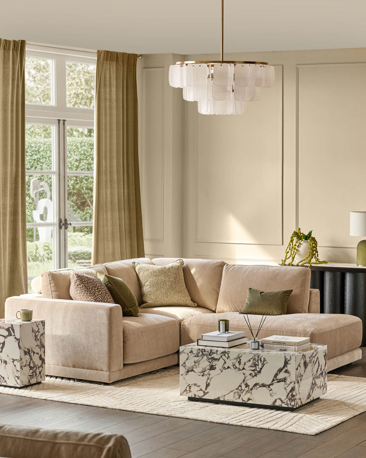 Champagne fabric right-facing small chaise sectional sofa with curved arms, displayed in a bright living room setting.
