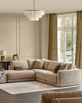 Champagne fabric left-facing sectional sofa with chaise lounge in a bright, neutral living room setting.