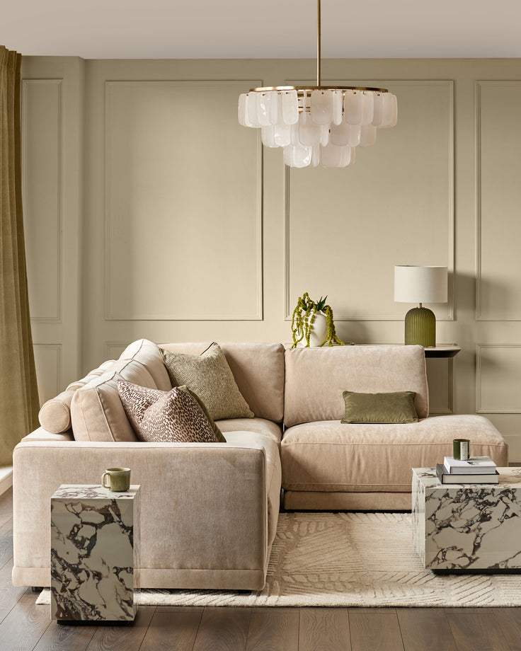 Eden right large chaise sofa in champagne fabric, displayed in a neutral living room setting with pillows and accessories.