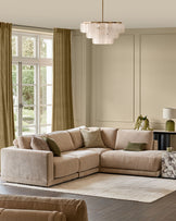 Champagne upholstered modular sofa section with rolled arms and cushioned seat in elegant living room setting.