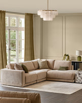 Eden right-facing large chaise sectional sofa in champagne fabric in a light-filled living room setting.