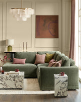 Eden left large chaise sofa in dark green fabric, styled in a modern living room with decorative pillows.