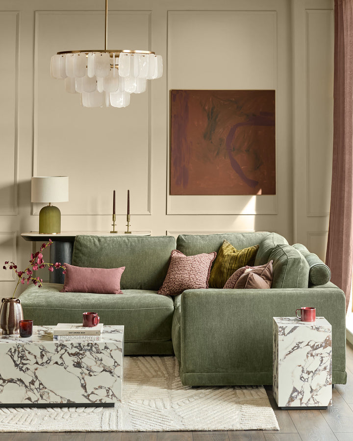 Eden left small chaise sofa in dark green fabric, displayed in a styled living room setting with coordinating pillows.