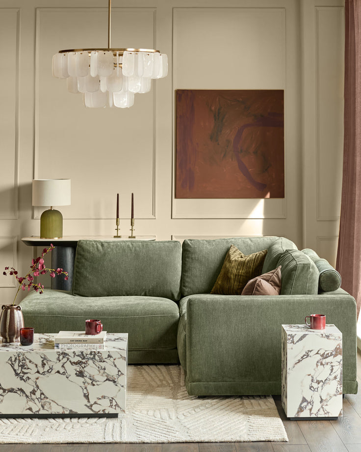 Dark green upholstered left-facing small chaise sectional sofa in a modern living room setting.