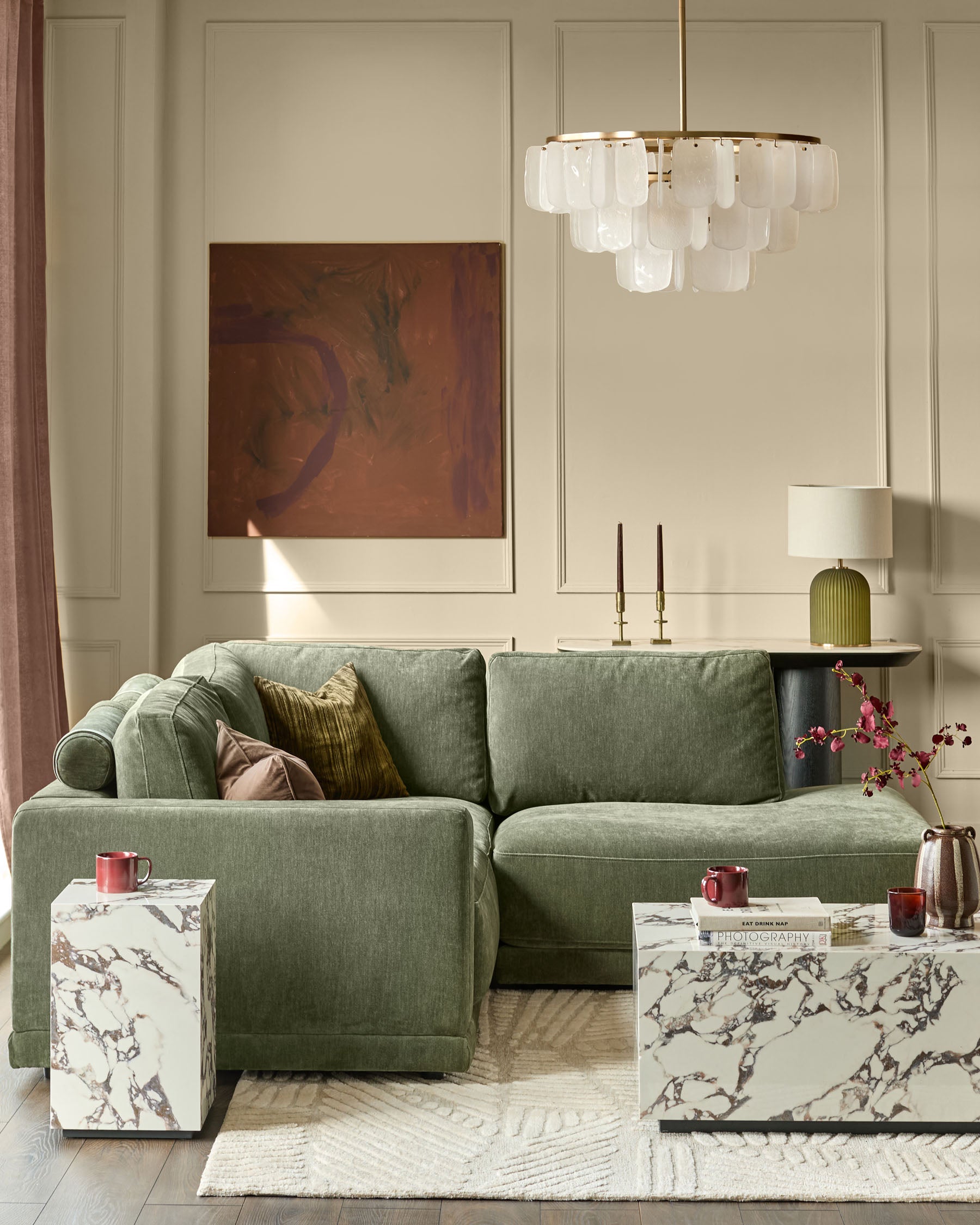 Dark green fabric right-facing small chaise sofa with rolled arms and cushioned back in modern living room setting.
