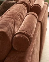 Eden left large chaise sofa in apricot fabric, close-up of cylindrical arm detail and stitching.