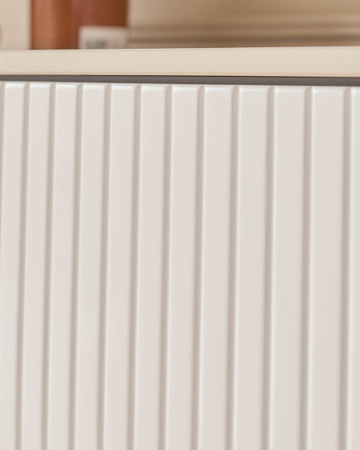 Edie Large Sideboard in natural ceramic with vertical ribbed paneling detail on the cabinet doors.