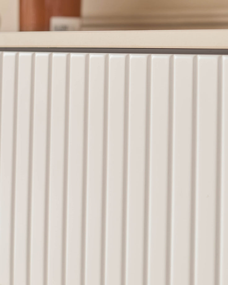 Edie Large Sideboard in natural ceramic with vertical ribbed paneling detail on the cabinet doors.