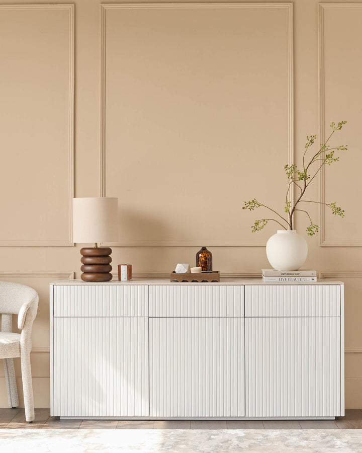 Edie Large Sideboard in natural ceramic with vertical ribbed fronts, displayed in a minimalist beige interior setting.
