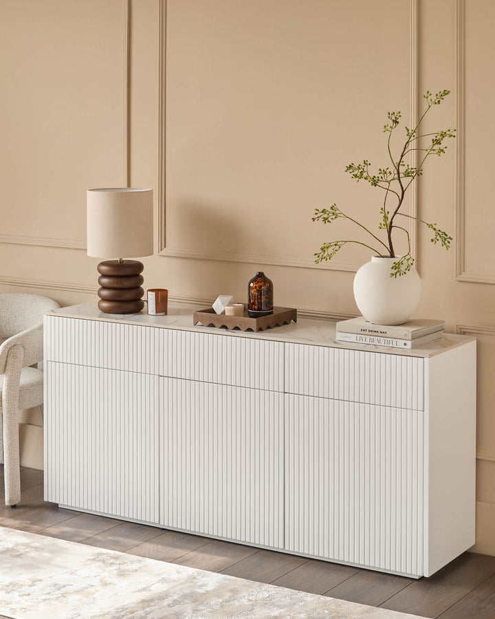 Edie Large Sideboard in natural ceramic with vertical ribbed front, displayed in a styled room setting with decor.