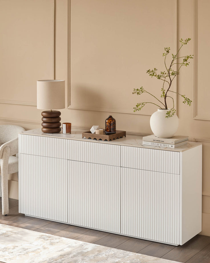 Edie Large Sideboard in natural ceramic with vertical ribbed front, displayed in a styled room setting with decor.