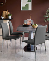 A modern dining set, featuring a grey table and chairs with chrome legs. A stylish and functional addition to any dining space.