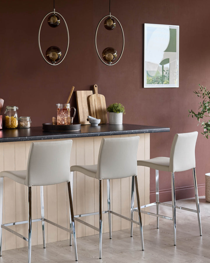 Elise light grey faux leather bar stool with chrome legs, shown at kitchen island counter in modern dining setting.