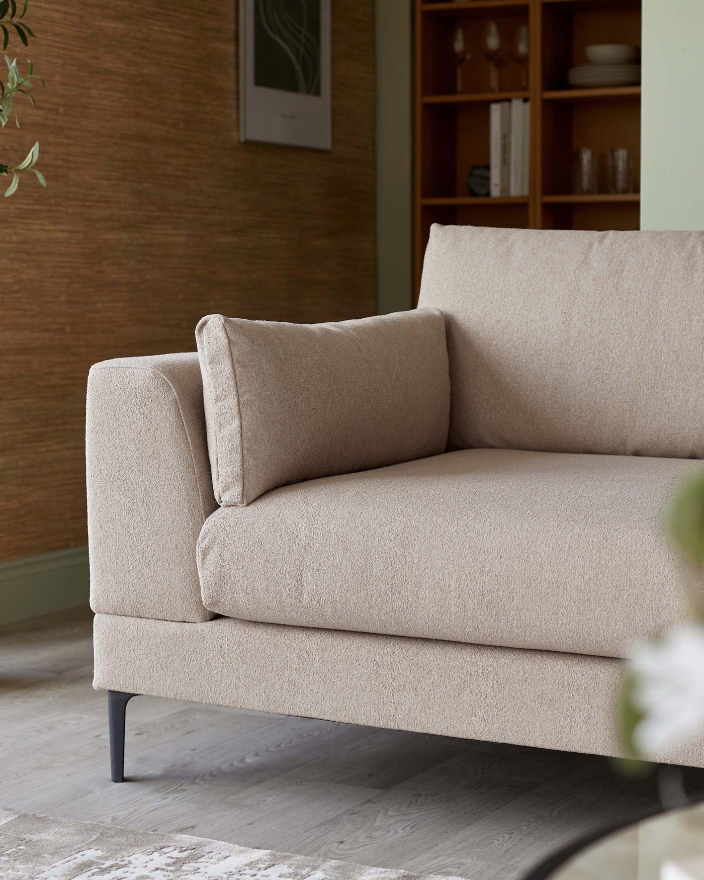 Contemporary beige upholstered sofa with a clean, minimalist design, featuring a single seat cushion, plush back cushion, square arms, and slender metal legs.