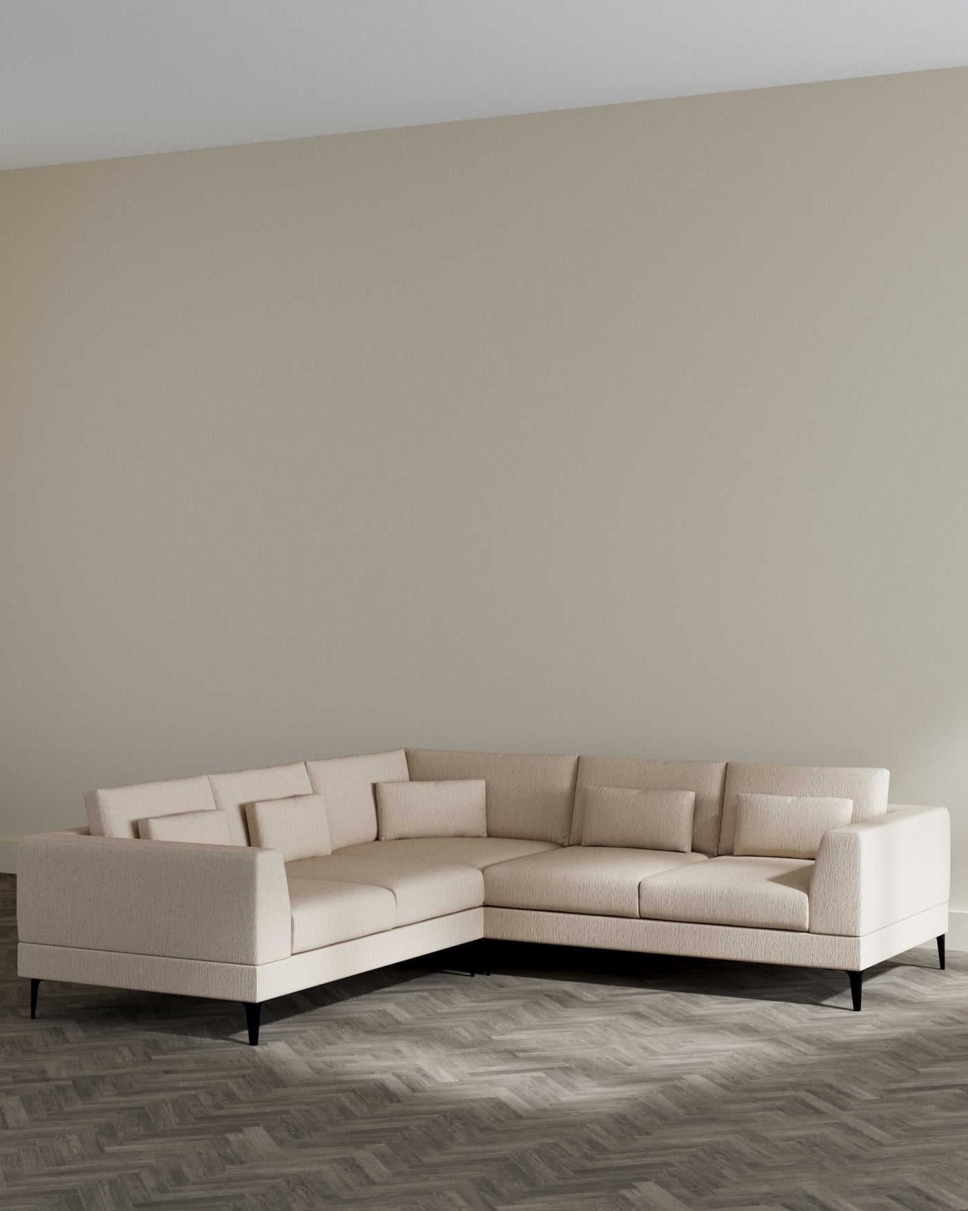 L-shaped sectional sofa with a minimalistic design, featuring a light beige upholstery and clean lines, supported by dark, tapered wood legs. The sofa includes multiple back cushions for added comfort, arranged in an open-concept space with herringbone wood flooring.