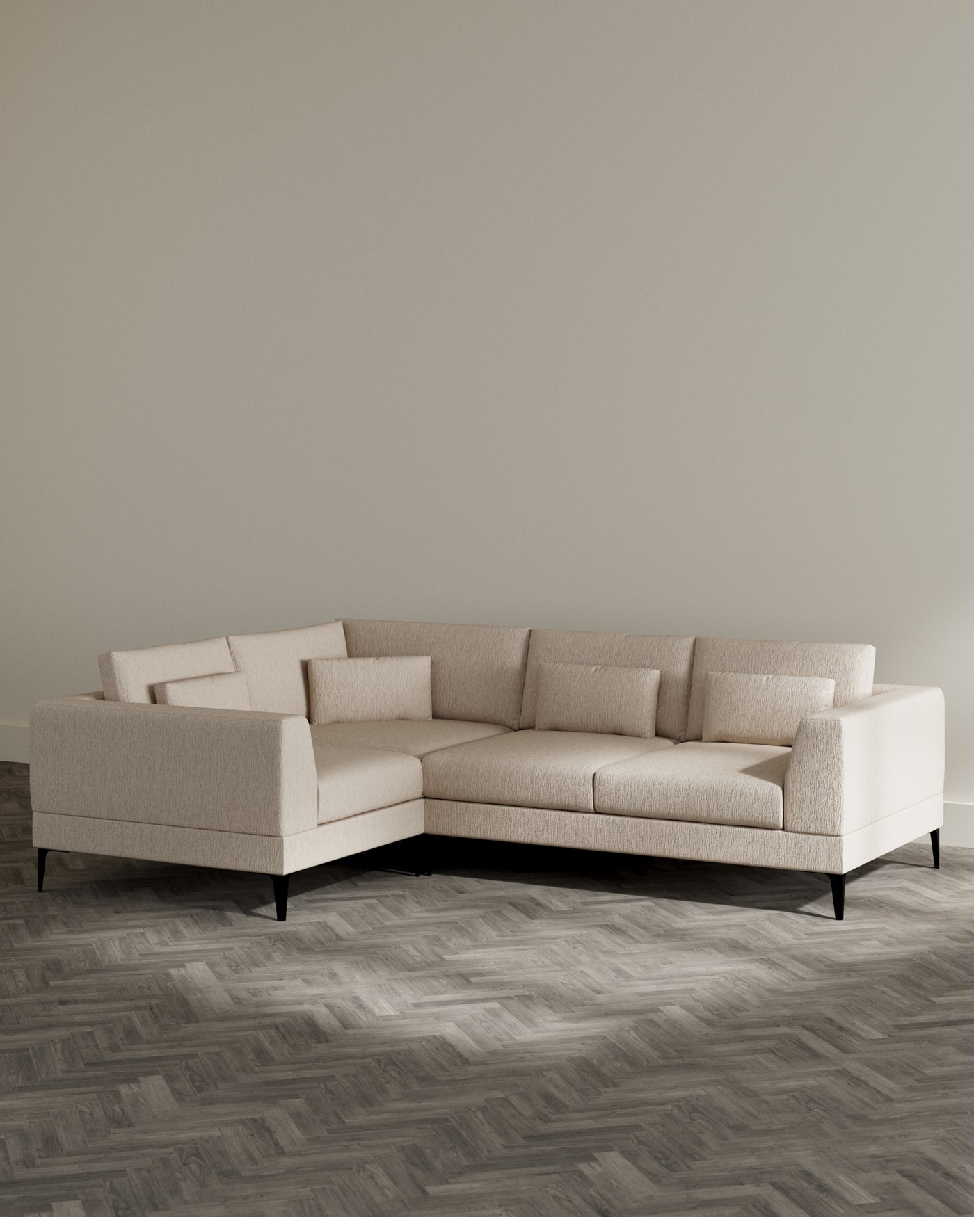 Contemporary L-shaped sectional sofa in a light beige fabric with a simple, elegant design. The sofa features clean lines, plush cushions, and low-profile black legs, creating a modern aesthetic suitable for a variety of living spaces.