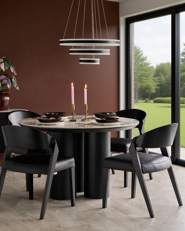 Enzo dining chair in black real leather, shown in modern dining room setting around marble table.