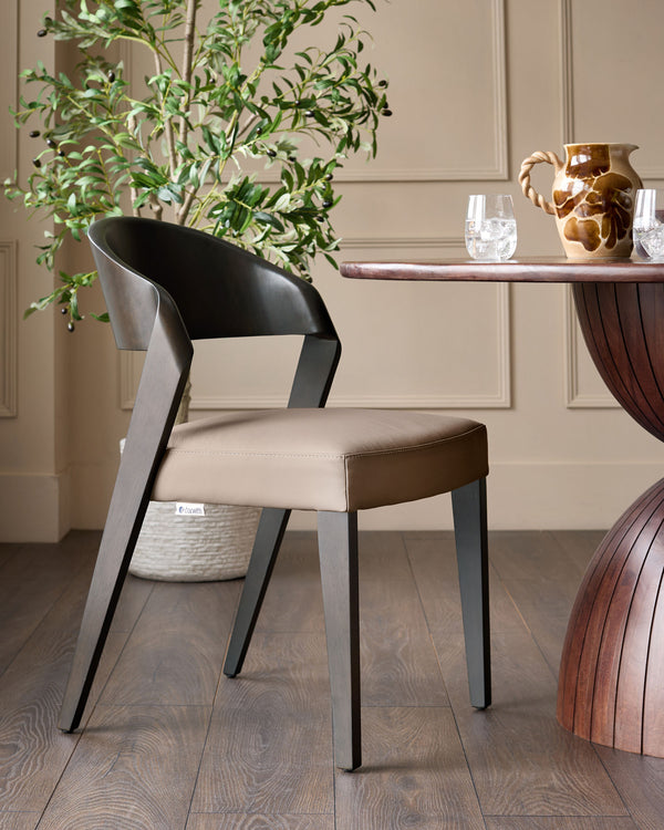Enzo dining chair in mocha leather with curved black backrest and dark legs, shown in a styled dining room setting.