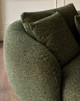 Dark green textured fabric left-hand corner chaise sofa with cushions, angled detail view