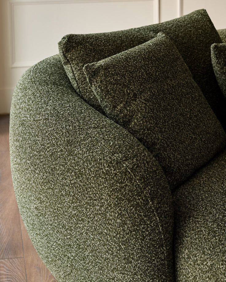 Dark green textured fabric left-hand corner chaise sofa with cushions, angled detail view