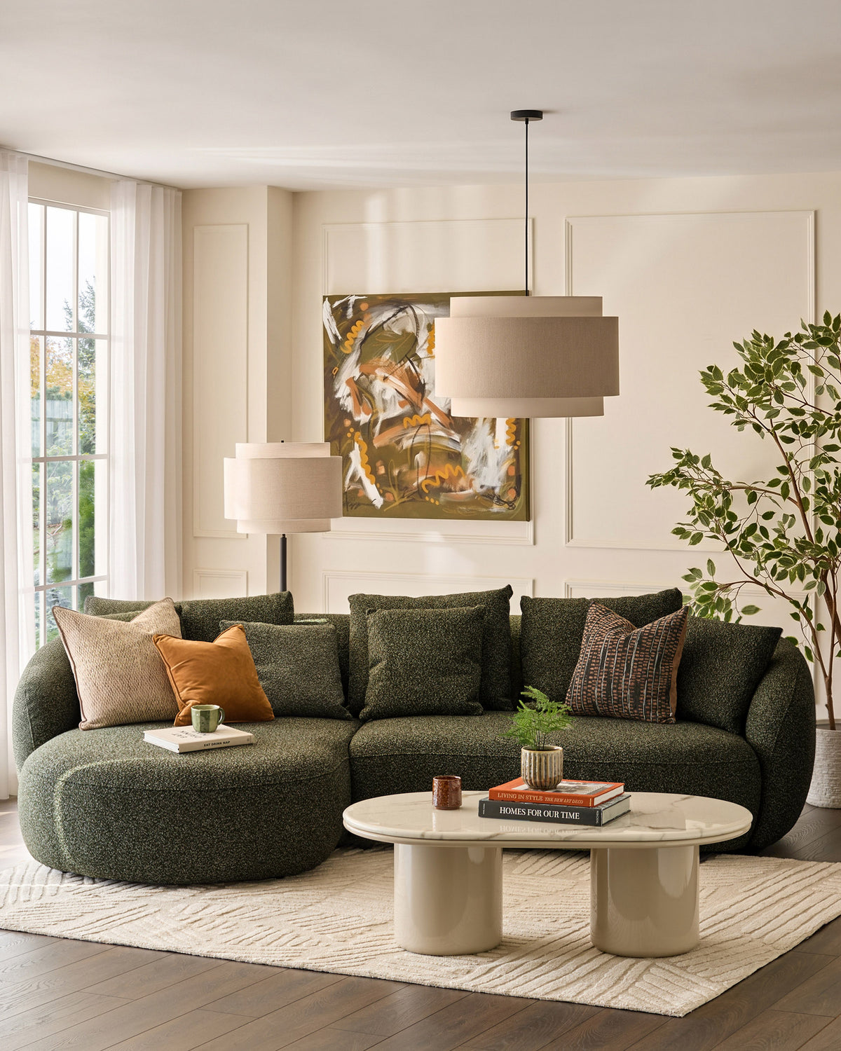 Dark green fabric left-hand corner chaise sofa with curved arms and plush cushions in a contemporary living room setting.