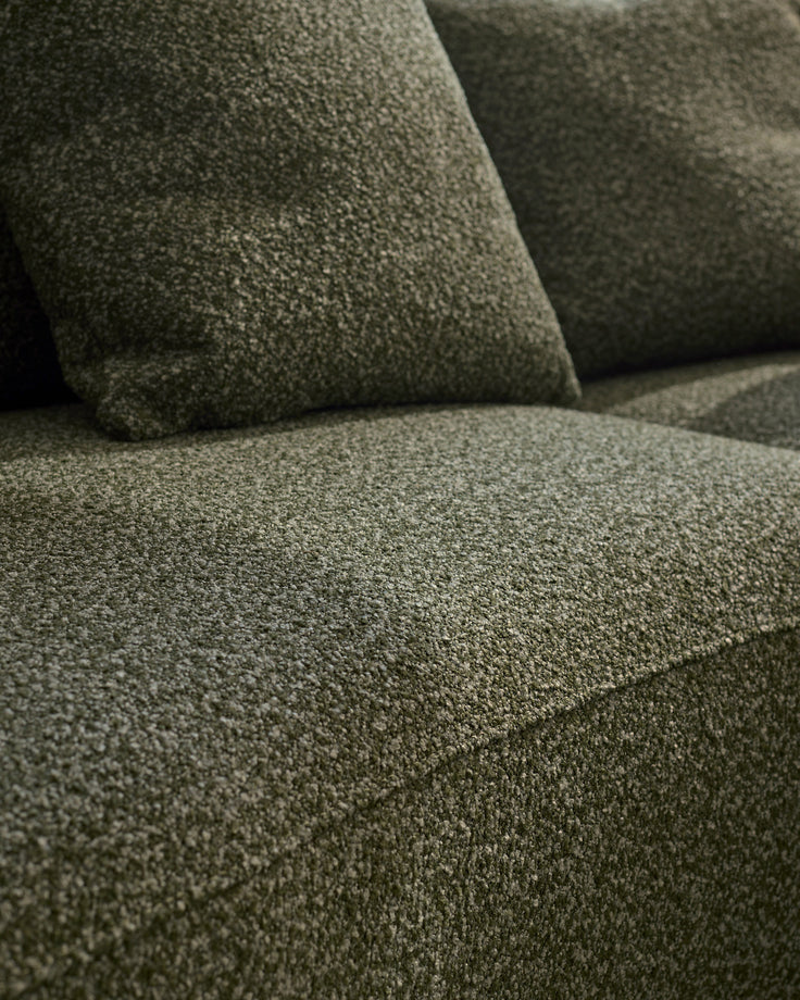 Close-up of dark green fabric upholstery on Eris right-hand corner chaise sofa, showing textured weave and cushion details.