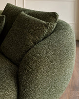Dark green textured fabric right-hand corner chaise sofa with rolled arms and matching cushions, angled view.