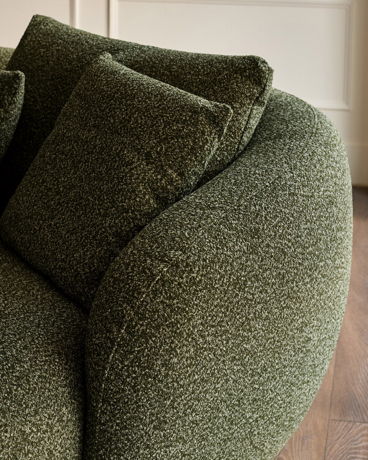 Dark green textured fabric right-hand corner chaise sofa with rolled arms and matching cushions, angled view.