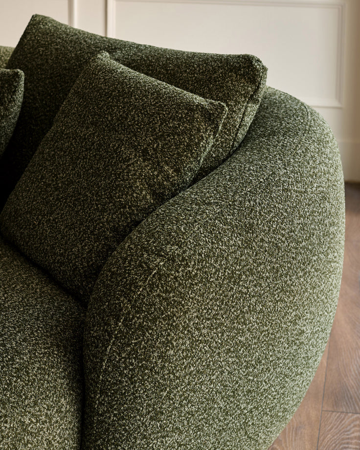 Dark green textured fabric right-hand corner chaise sofa with rolled arms and matching cushions, angled view.