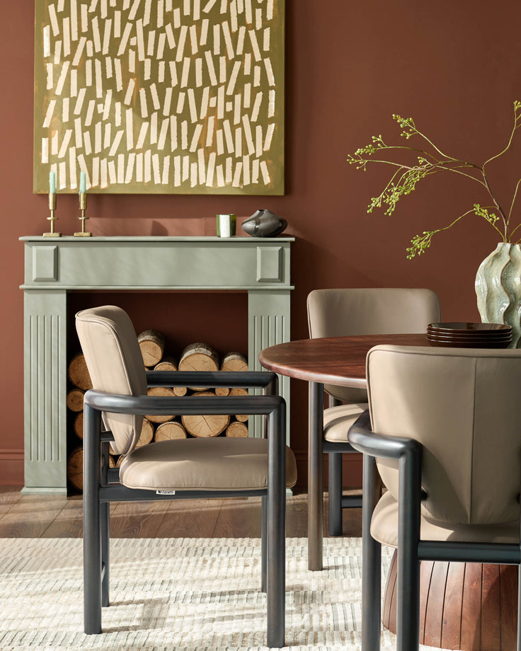 Esme dining chair in mocha leather with black metal frame, shown in a styled dining room setting.