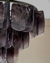 Estelle chandelier with smoked ombre glass panels hanging from metal rod, close-up detail view.
