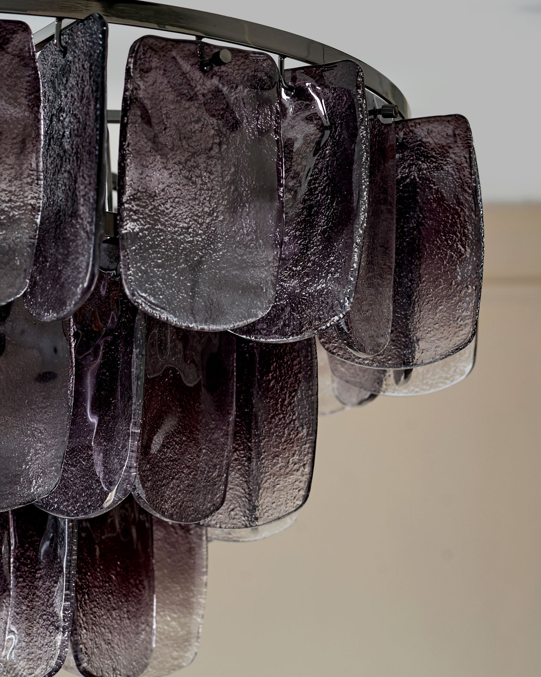 Estelle chandelier with smoked ombre glass panels hanging from metal rod, close-up detail view.