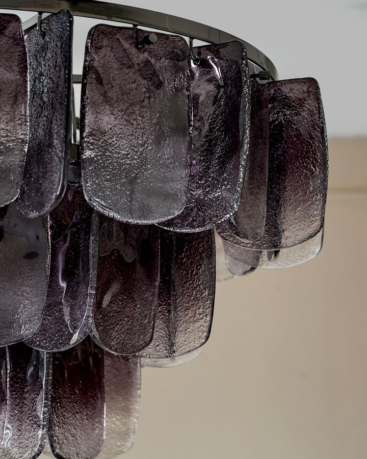 Estelle chandelier with smoked ombre glass panels hanging from metal rod, close-up detail view.