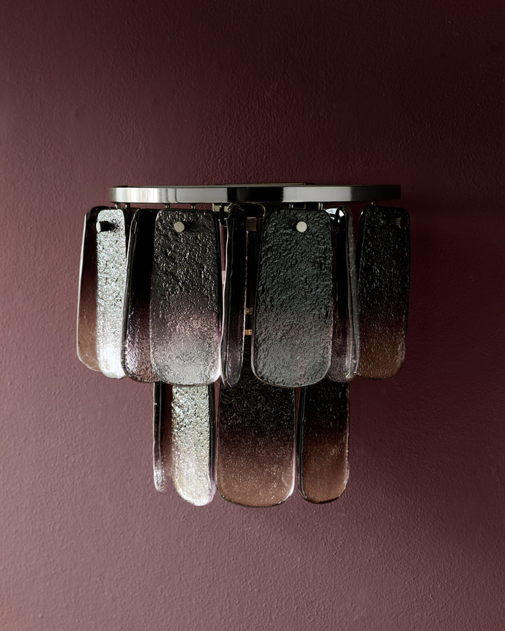 Estelle wall light with smoked ombre glass panels and chrome fixture against mauve background.