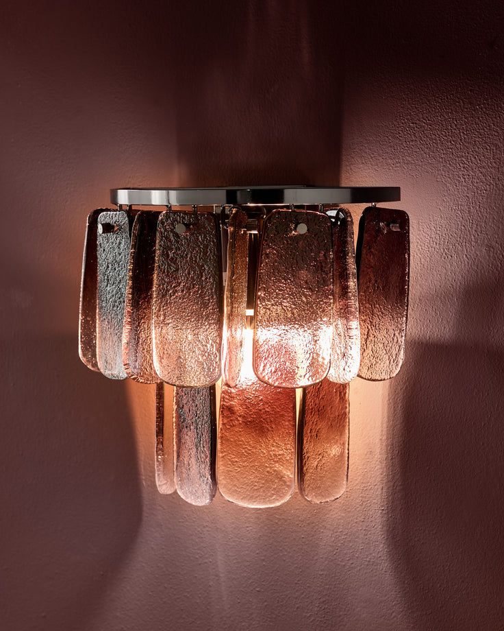 Estelle wall light with smoked ombre glass panels in copper tones, mounted on wall with warm ambient glow.