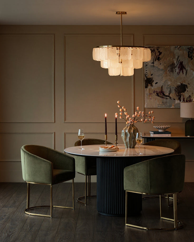 Dakota dining chair in olive green velvet with brass frame, shown in elegant dining room setting.