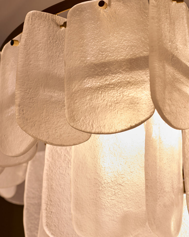 Estelle chandelier with white frosted glass panels and brass hardware detail, close-up of scalloped shade design.