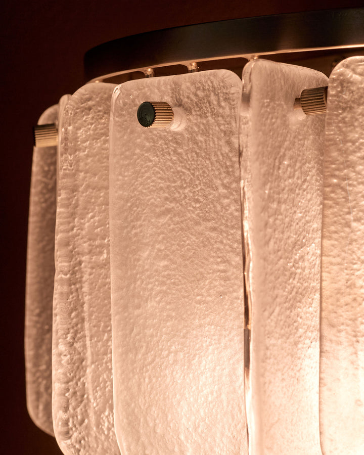 Estelle wall light with white textured glass shades hanging from a dark metal fixture, close-up detail view.