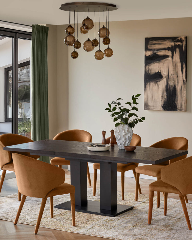 Dining room featuring a dark wood table, amber chairs, a unique light fixture, and abstract art.