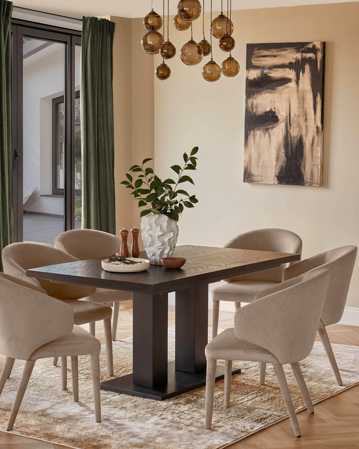 Champagne velvet dining chair with curved backrest and wooden legs, shown at dining table in neutral interior.